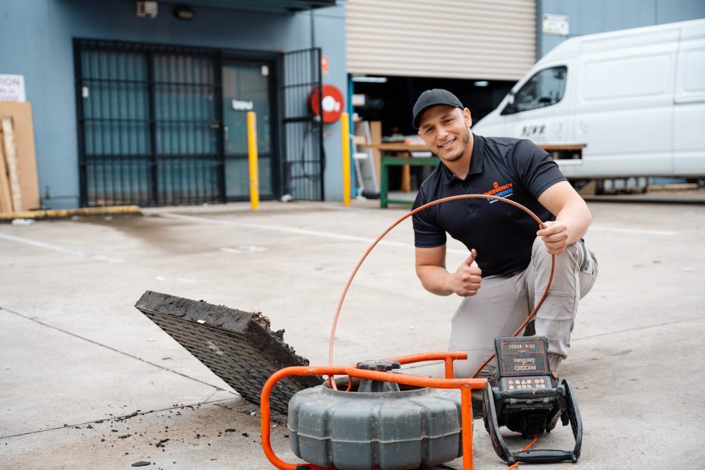 Plumber fixing the stormwater drain